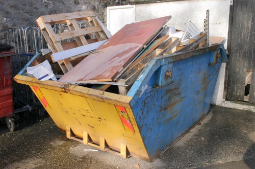 People disposing of old furniture outside their Haringey home