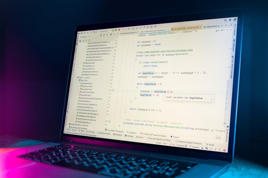 A computer screen displaying a close-up view of a code editor with multicolored lines of programming code, predominantly featuring red, green, blue, and purple syntax highlighting on a dark background